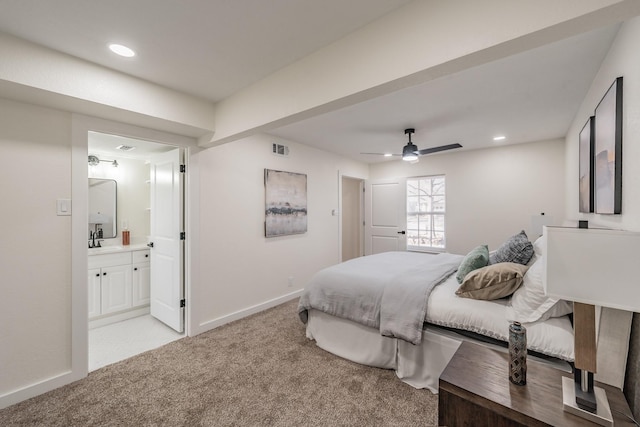 carpeted bedroom featuring ceiling fan, sink, and ensuite bath