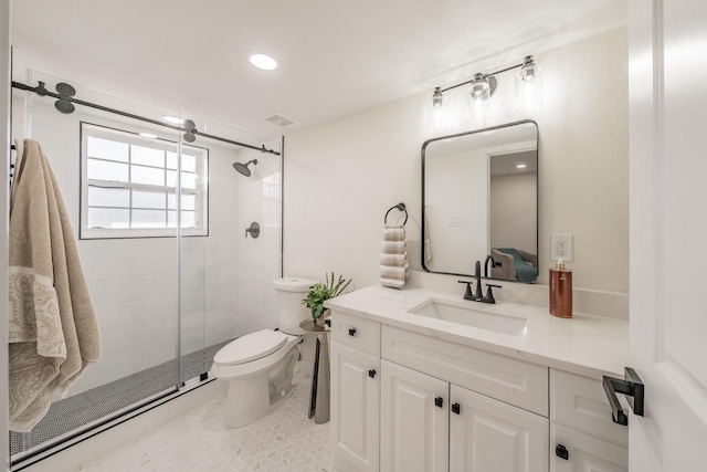 bathroom featuring vanity, toilet, and an enclosed shower