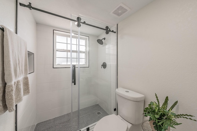 bathroom featuring an enclosed shower and toilet