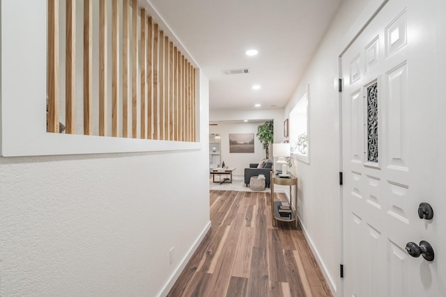 corridor with hardwood / wood-style floors