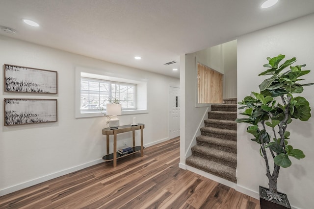 stairs featuring wood-type flooring