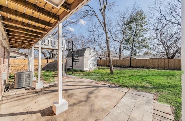 view of patio with cooling unit and a shed