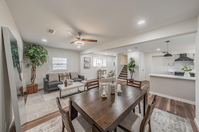 dining space with ceiling fan and hardwood / wood-style floors