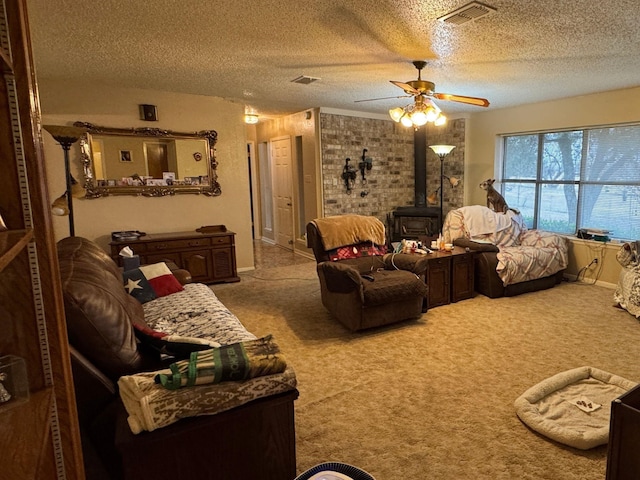 carpeted living room featuring ceiling fan, a wood stove, and a textured ceiling