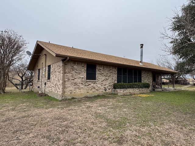 view of side of home featuring a lawn