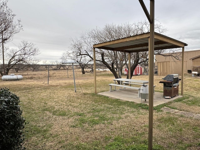 view of yard with a patio and a shed