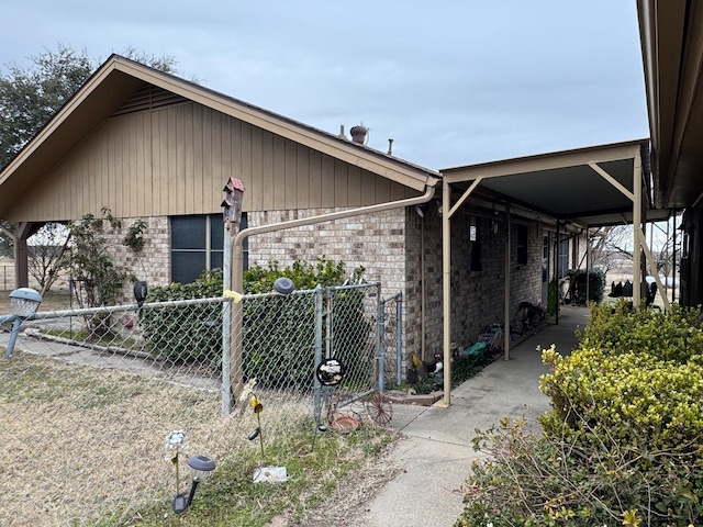 view of side of home with a carport