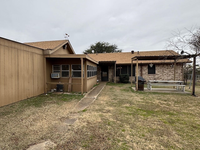 exterior space featuring a front yard and cooling unit