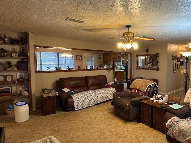 living room featuring ceiling fan, light colored carpet, and a textured ceiling