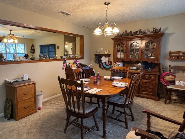 dining room featuring ceiling fan with notable chandelier, a textured ceiling, and carpet flooring