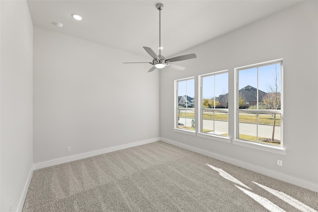 carpeted spare room with ceiling fan and a healthy amount of sunlight