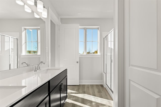 bathroom featuring an enclosed shower, hardwood / wood-style floors, and vanity