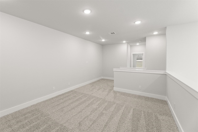 unfurnished room featuring light colored carpet