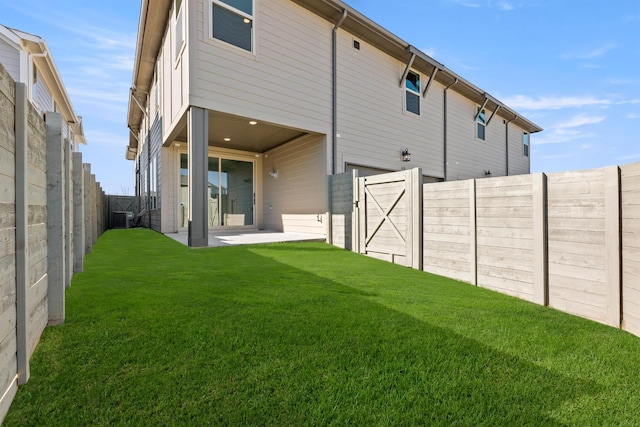 back of house featuring a yard, cooling unit, and a patio area