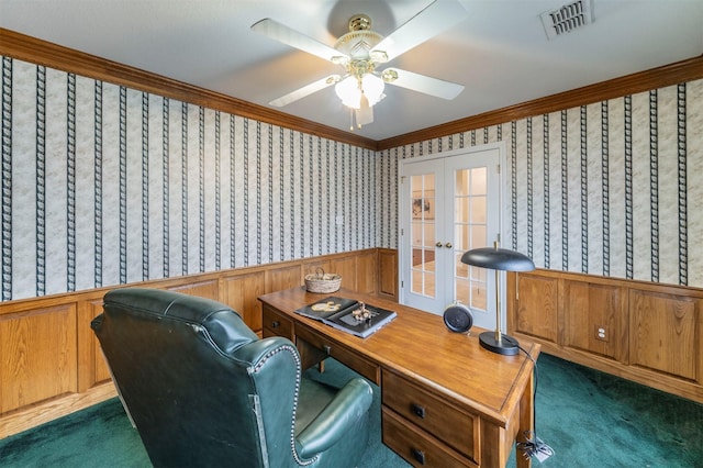 office area featuring a wainscoted wall, visible vents, french doors, dark carpet, and wallpapered walls