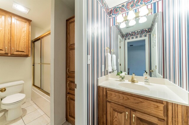 full bathroom with tile patterned floors, vanity, and wallpapered walls