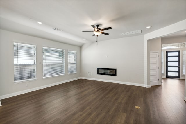 unfurnished living room featuring dark wood-type flooring, ceiling fan, and lofted ceiling