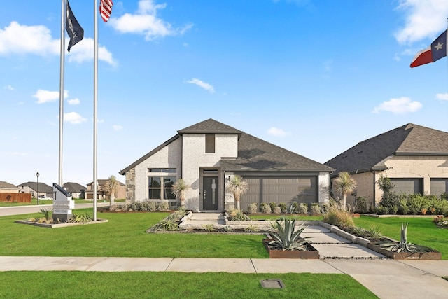 view of front of property featuring a garage and a front yard