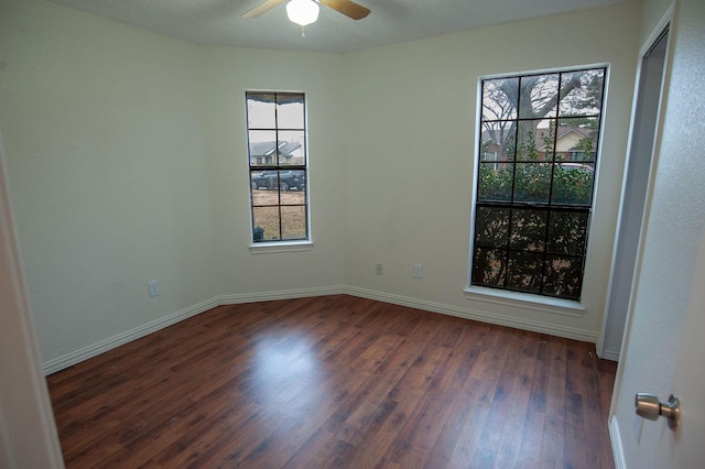 spare room featuring dark hardwood / wood-style floors and ceiling fan