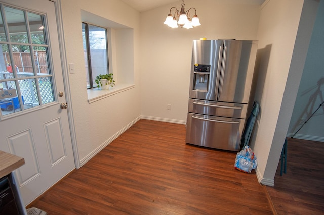 kitchen with an inviting chandelier, dark hardwood / wood-style flooring, stainless steel fridge with ice dispenser, and hanging light fixtures