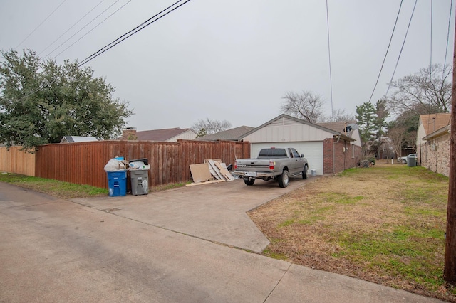 view of home's exterior with a garage and a yard