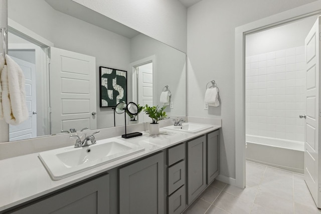 bathroom with tile patterned flooring, vanity, and  shower combination