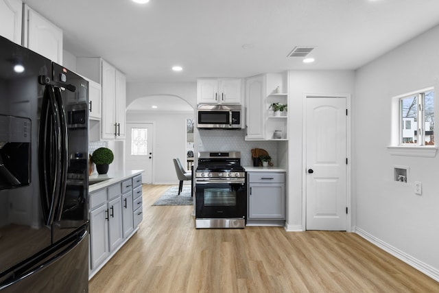 kitchen featuring white cabinetry, a wealth of natural light, tasteful backsplash, and appliances with stainless steel finishes