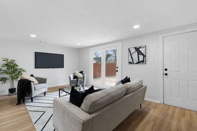 living room featuring light hardwood / wood-style flooring and french doors