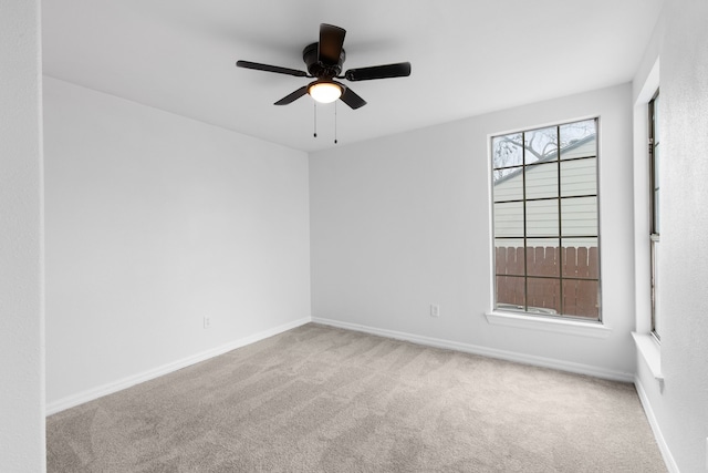 unfurnished room with a healthy amount of sunlight, ceiling fan, and carpet flooring