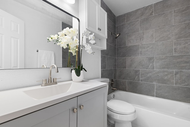 full bathroom featuring vanity, toilet, and tiled shower / bath