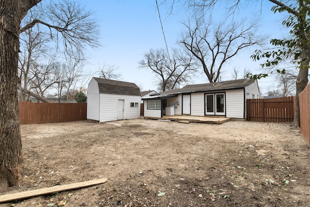 back of property featuring a storage unit