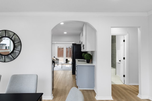 interior space with crown molding and light wood-type flooring