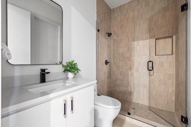 bathroom with vanity, toilet, and walk in shower