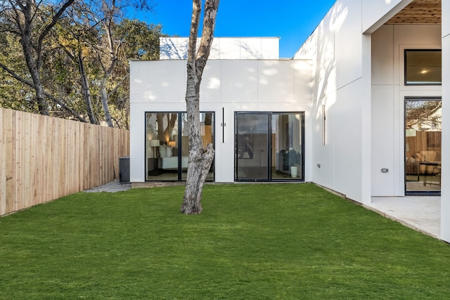 rear view of house with a yard