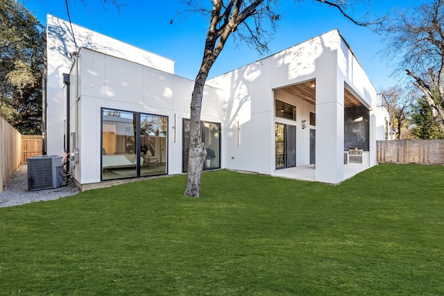 back of house featuring a patio, central AC unit, and a lawn