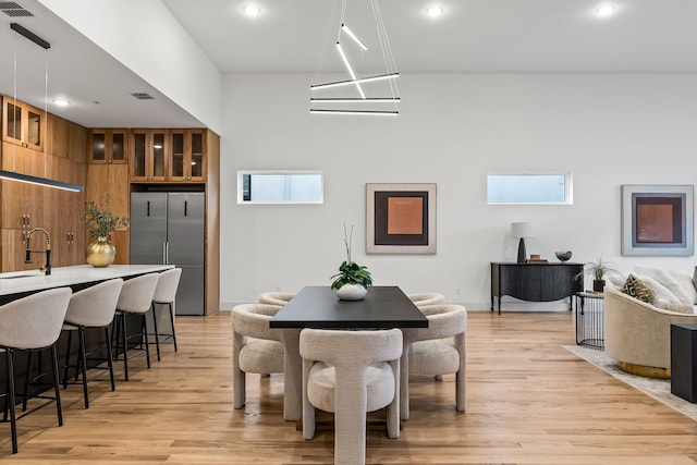 dining space with sink and light wood-type flooring