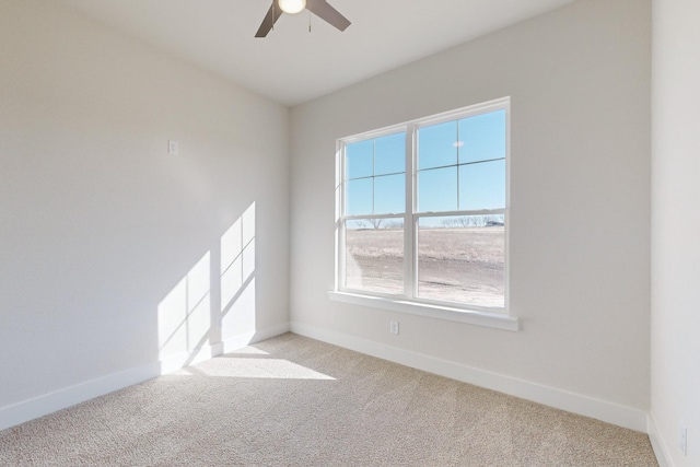 spare room with light colored carpet and ceiling fan