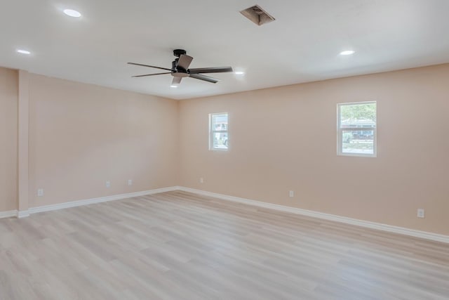 empty room with ceiling fan and light wood-type flooring