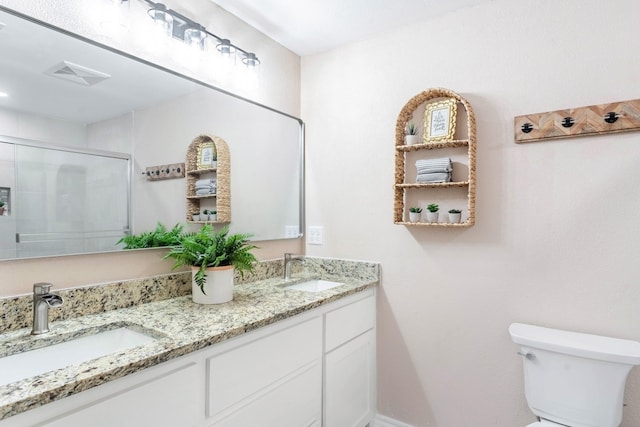 bathroom with vanity, toilet, and walk in shower