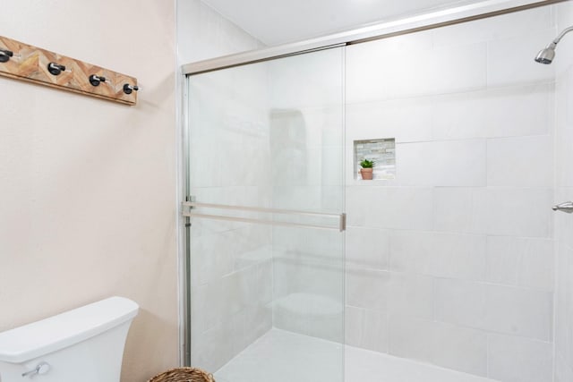 bathroom with walk in shower and toilet