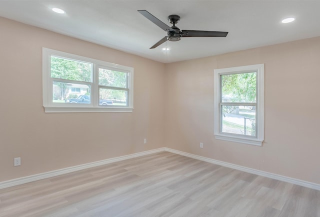 empty room with ceiling fan and light wood-type flooring