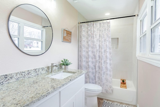 full bathroom featuring vanity, toilet, and shower / tub combo with curtain