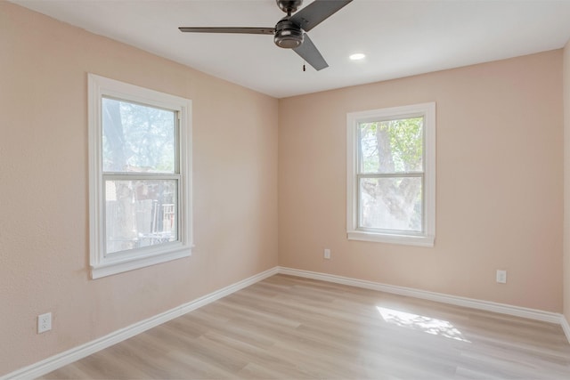 empty room with ceiling fan and light hardwood / wood-style floors