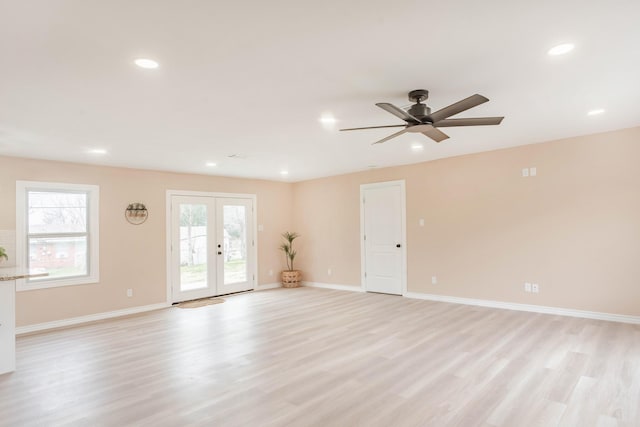 unfurnished living room with ceiling fan, light hardwood / wood-style floors, and french doors