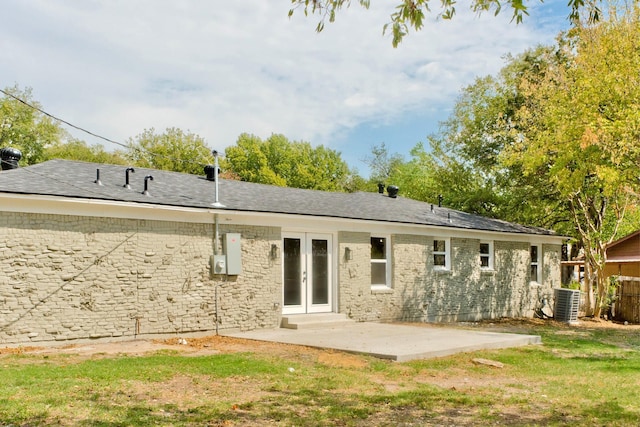 back of house with french doors, a patio, central AC, and a lawn