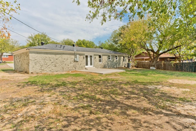 back of house with a patio and a yard