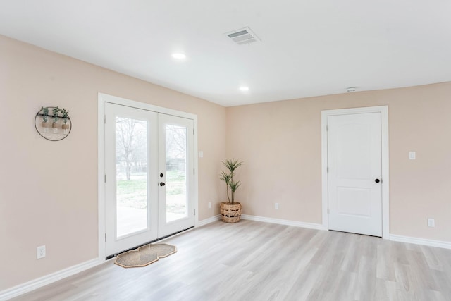 doorway with light hardwood / wood-style floors and french doors