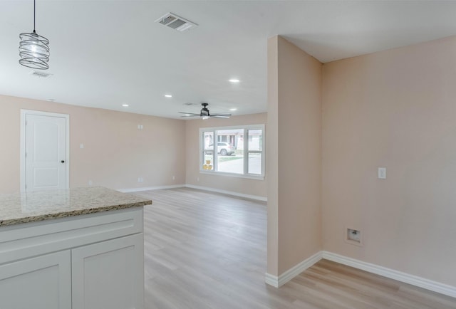 unfurnished living room with ceiling fan and light hardwood / wood-style flooring