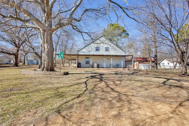 rear view of property featuring a yard