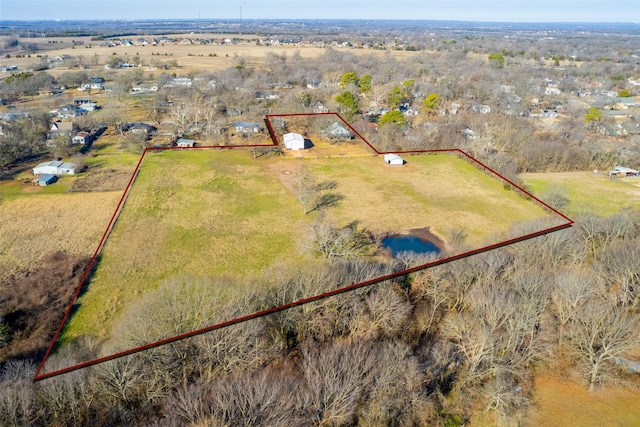 birds eye view of property with a rural view